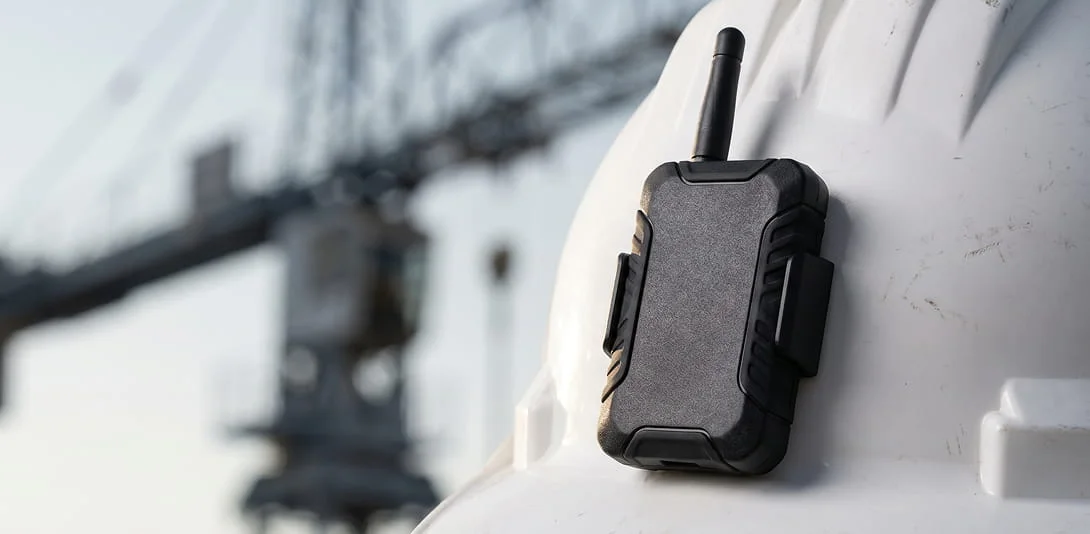 ASSET-Rx UWB transponder mounted on a hard hat at a construction site