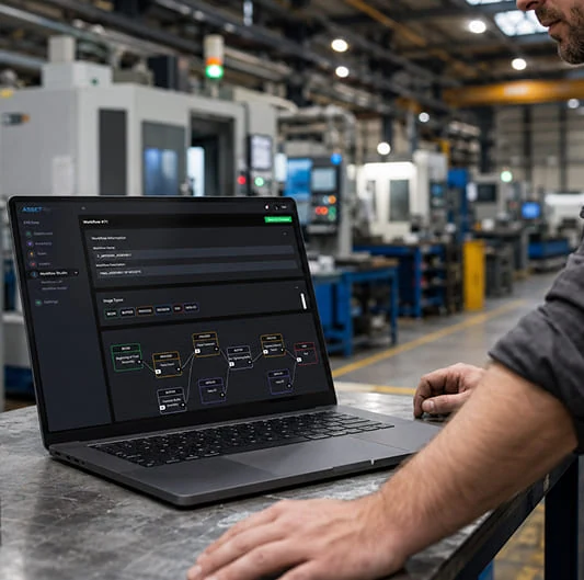 Operator using ASSET-Rx Workflow Studio on a laptop on an industrial shop floor