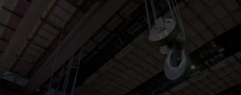 Overhead crane lifting hook used in industrial facility for heavy equipment safety and EHS compliance