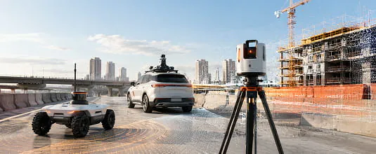 Tripod mounted LiDAR scanner, survey vehicle and autonomous rover working a construction site