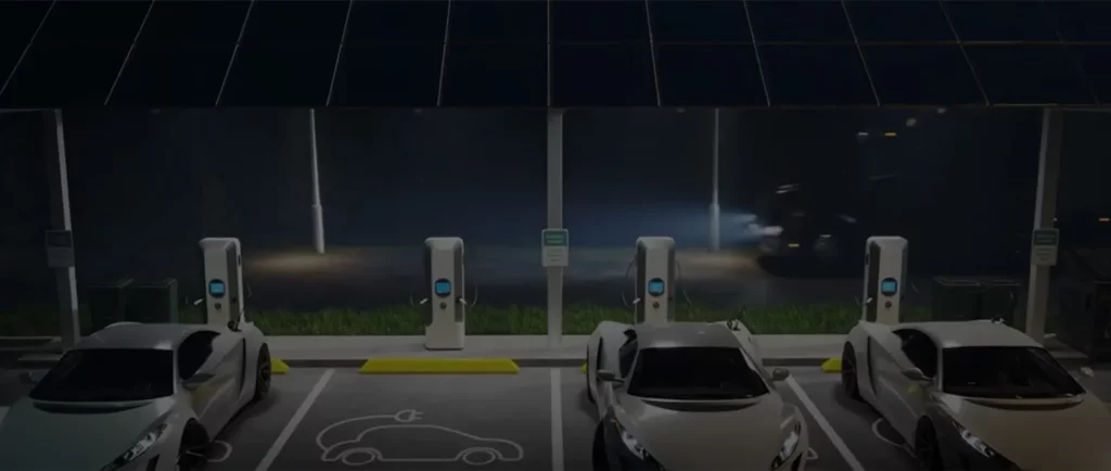 Electric vehicles charging at modern EV charging stations during nighttime with illuminated charging ports