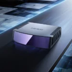 Hesai ETX automotive LiDAR sensor with purple optical window and heat sink fins mounted on vehicle roof surface, showing compact 600g design with HESAI branding for autonomous driving applications