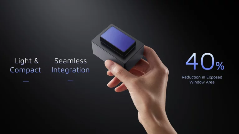 Hand holding compact HESAI FTX lidar sensor with blue scanning window, demonstrating ultra-compact size and 40% reduction in exposed window area