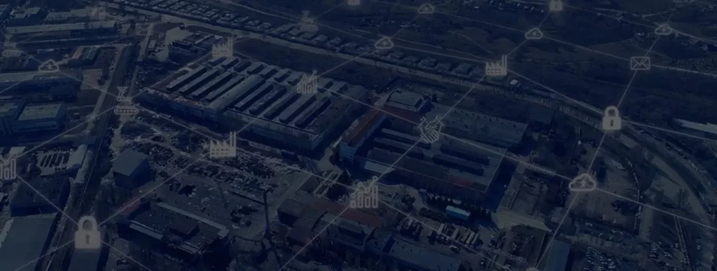 Aerial view of industrial facility with IoT-enabled battery management system network overlay showing connected infrastructure