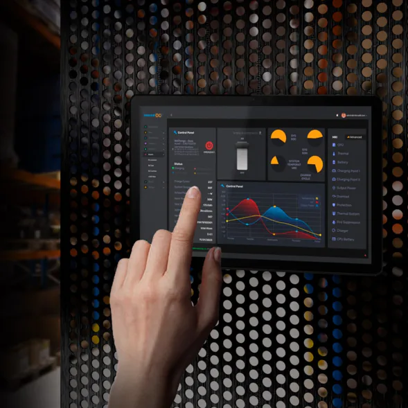 Hand using an INTERCAL8 energy management touchscreen showing energy charts