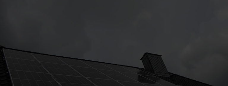 A residential rooftop equipped with modern solar panels under cloudy weather, representing Intercal8 hybrid inverter energy systems.