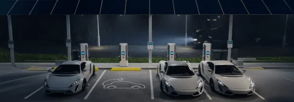 Electric vehicles charging at modern EV charging stations during nighttime with illuminated charging ports