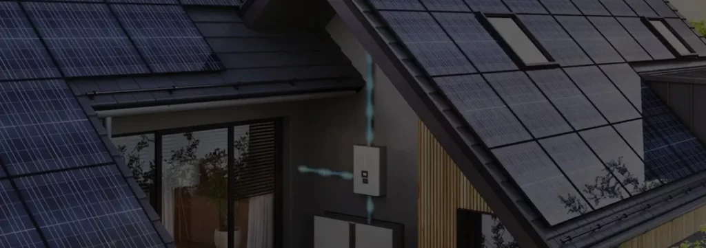 Aerial view of modern home with extensive solar panel installation on roof, showing residential microgrid system for energy independence
