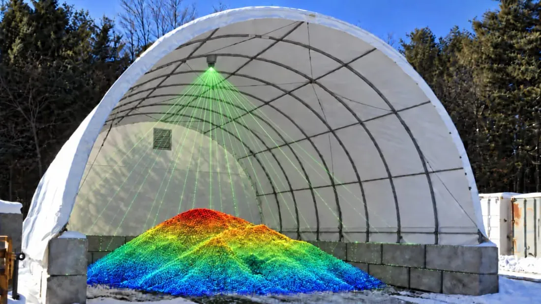 Fabric-covered storage building with a green scan beam and a color-coded 3D pile model